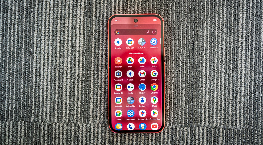 Google Pixel 10a v červenej farbe so zapnutým displejom a prehľadom aplikácií