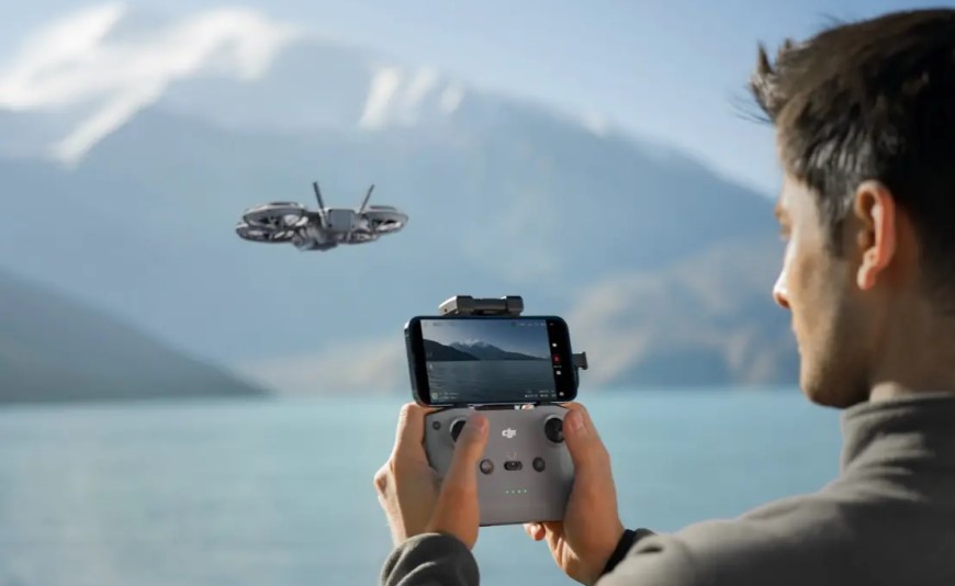 Nový DJI Neo 2: Malý dron so 4K kamerou a všesmerovou detekciou prekážok Muž ovláda dron DJI Neo 2 pomocou telefónu pri jazere.