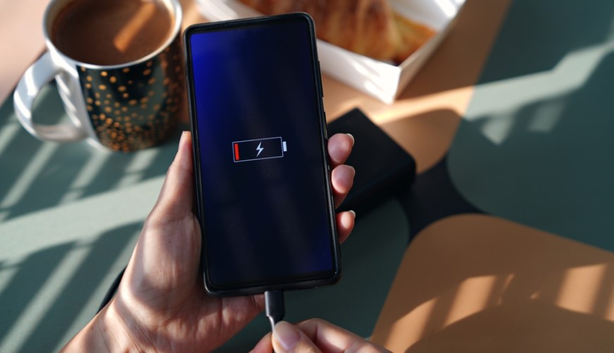 Ako aktualizovať Android: Kompletný sprievodca a užitočné rady Mobilný telefón pripojený k nabíjačke. Na displeji vidíme symbol vybitej batérie.