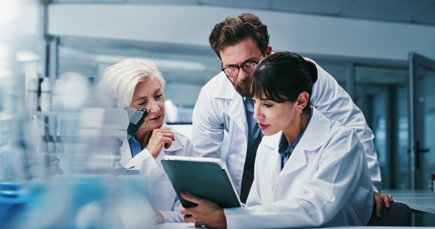 vedci v laboratóriu po zerajúci do tabletu