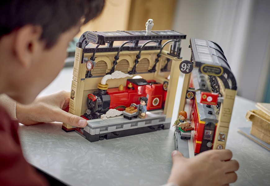 Chlapec sa pri stole hrá so stavebnicou LEGO® Harry Potter™ 76450 Knižná zarážka: Rýchlik do Rokfortu.